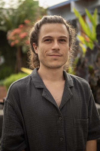Layf, Spanish teacher, smiling in a garden